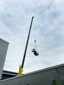 Nosturin puomi näkyy Tyks-sairaalarakennuksen takaa, puomissa riippuu henkilönostin, jota nostetaan sisäpihalle.